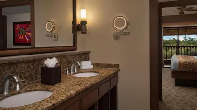 a bathroom with two sinks and a mirror at Disney's Animal Kingdom Villas - Jambo House in Orlando