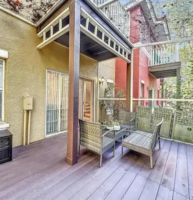 a patio with two chairs and a table on a deck at Scenic 3BR Family Retreat, Pool, Gym, 3mi to Disney in Kissimmee
