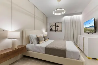 a white bedroom with a bed and a white cabinet at BRAND Themed Luxury 5Bedrooms At Paradiso Grande in Orlando
