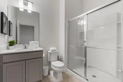 a bathroom with a shower and a toilet and a sink at BRAND Themed Luxury 5Bedrooms At Paradiso Grande in Orlando