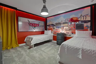 a room with two beds and a coca cola mural at Brand New Home 9 Bedrooms5 Baths At Storey Lake in Kissimmee