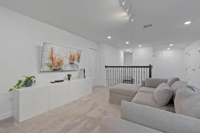 a living room with a couch and a table at Brand New Home 9 Bedrooms5 Baths At Storey Lake in Kissimmee
