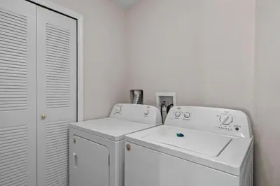 a white laundry room with a washer and dryer at Sweet 3 bedroom Townhome 2407 in Orlando