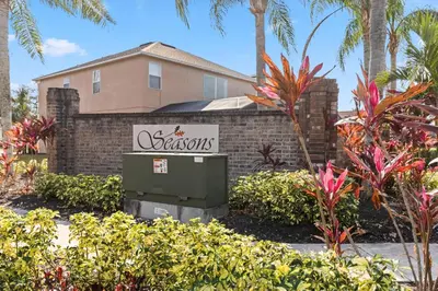 a sign in front of a house with palm trees at 765 Beautiful Vacation Home With Private Pool, And Much More!! in Kissimmee