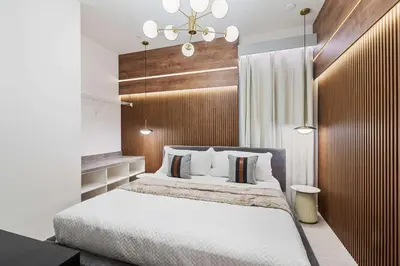 a bedroom with a large bed with a wooden headboard at 5911 Luxury 10BD Family Home For an Unforgettable Vacation in Orlando