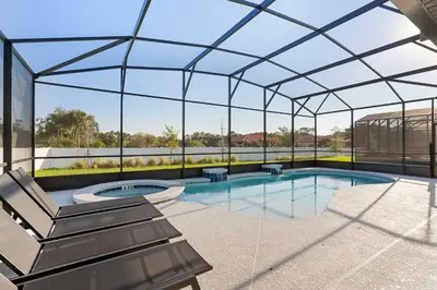 an indoor swimming pool with a glass roof at 5911 Luxury 10BD Family Home For an Unforgettable Vacation in Orlando