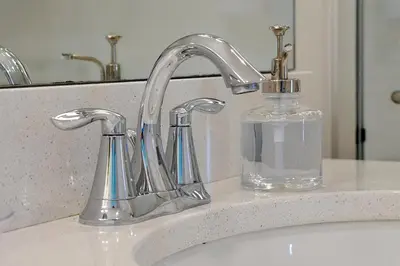 a bathroom sink with a soap dispenser next to a sink at Family-Friendly home w/ Pool & Resort Perks Near Disney in Orlando