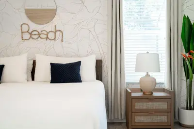 a bedroom with a bed and a wall with a sign on it at Disney THEMED HOME, PRIVATE HEATED POOL, COMMUNITY WATERPARK in Orlando