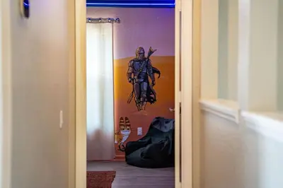 a door with a painting of a man on the wall at Disney THEMED HOME, PRIVATE HEATED POOL, COMMUNITY WATERPARK in Orlando