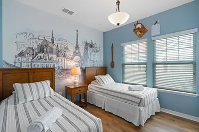 a bedroom with two beds and a mural on the wall at Themed Villa, Great Location with proximity to Disney in Kissimmee