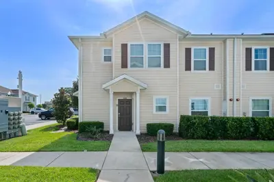 a house in a residential neighborhood with a driveway at Luxury Design with close proximity to DISNEY in Kissimmee
