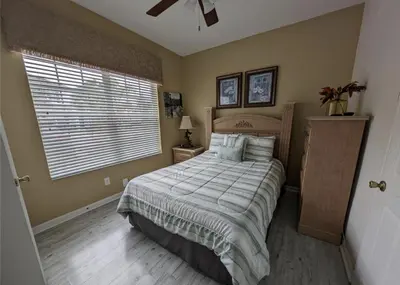 a bedroom with a large bed and a window at Beautiful 3 bed townhome in Windsor Hills Resort in Orlando
