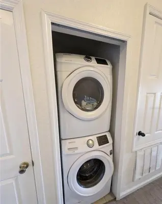 a washer and dryer inside of a room at Beautiful 3 bed townhome in Windsor Hills Resort in Orlando