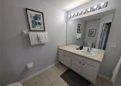 a bathroom with a sink and a mirror at Beautiful 3 bed townhome in Windsor Hills Resort in Orlando