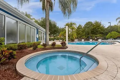 a swimming pool with a roundabout in front of a building at Casa 4Q c/ Clubhouse – 10 Min da Disney in Kissimmee