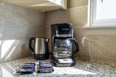 a coffeemaker sitting on top of a counter with energy drinks at Casa 4Q c/ Clubhouse – 10 Min da Disney in Kissimmee