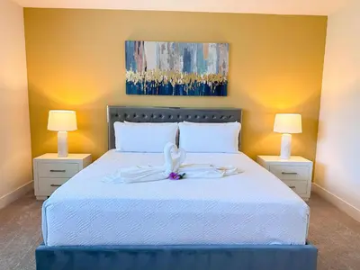 a bedroom with a white bed with two lamps at TR1459SL - Brand new Star Wars property with pool in Orlando
