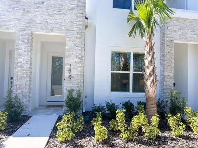 a palm tree in front of a house at TR1459SL - Brand new Star Wars property with pool in Orlando