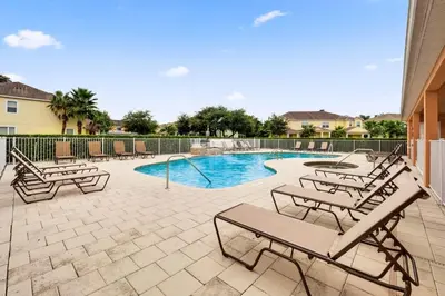 a swimming pool with chaise lounge chairs and a swimming pool at TR1459SL - Brand new Star Wars property with pool in Orlando