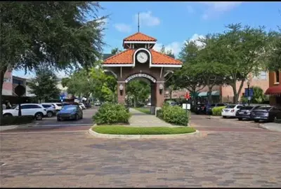 a clock tower in the middle of a parking lot at FunTropicalTinyHomeGolfCartLake in Orlando