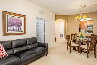 a living room with a black couch and a table at Dream 4814 Condo At Vista Cay in Orlando