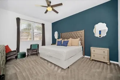a bedroom with a bed and a ceiling fan at EPIC 12 Bedroom Home with Private Pool in Kissimmee