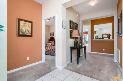 a hallway with a room with a bed and a table at BellaVida Palms Private Screened Pool Home in Kissimmee