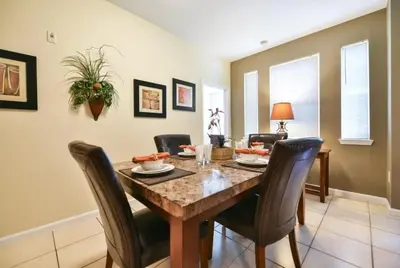 a dining room with a table and chairs at Resort Condo with all amenities needed-Cane Island in Kissimmee