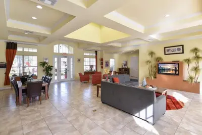 a large living room with a couch and a table at Resort Condo with all amenities needed-Cane Island in Kissimmee