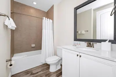 a bathroom with a sink and a toilet and a mirror at Key Lime Villa By The Lake Near Disney With Margaritaville Resort & Island H20 Waterpark Access - 3105Cs in Orlando