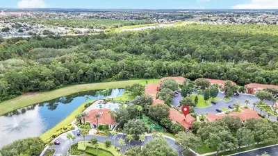 an aerial view of a resort with a golf course and a lake at Townhome Perfectly Located Near Clubhouse in Kissimmee
