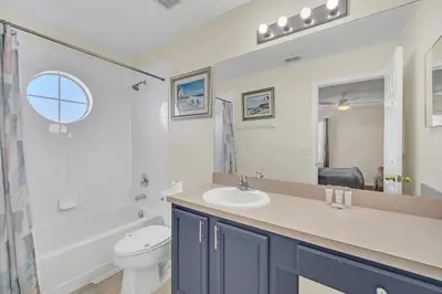 a bathroom with a sink and a toilet at Emerald Island Resort 6 bedroom 4 bathroom luxury in Kissimmee