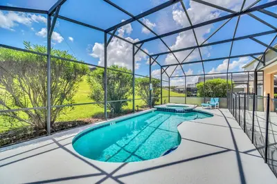 an indoor swimming pool in a glass house at Emerald Island Resort 6 bedroom 4 bathroom luxury in Kissimmee