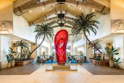 a large red surfboard in a room with palm trees at Lovely Villa Near Disney With Margaritaville Resort Access - 3124Cs in Orlando