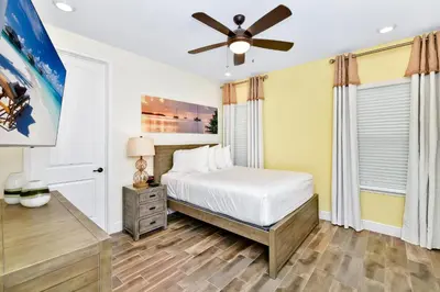 a bedroom with a bed and a ceiling fan at Lovely Villa Near Disney With Margaritaville Resort Access - 3124Cs in Orlando