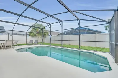 a swimming pool with a pergola over it at Cute Vacation Home Very Close to Disney in Orlando