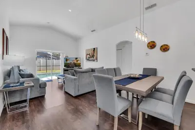 a dining room and living room with a table and chairs at Cute Vacation Home Very Close to Disney in Orlando