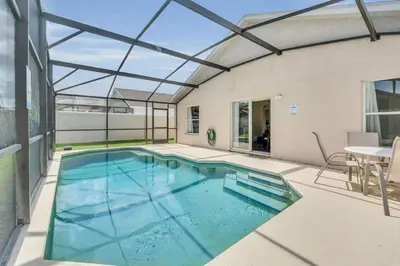 an indoor swimming pool with a glass roof at Cute Vacation Home Very Close to Disney in Orlando