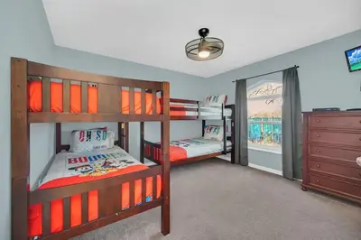 two bunk beds in a room with a window at Lindfields Reserve with Private Pool in Kissimmee