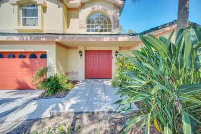 a red door on a house with a driveway at Lindfields Reserve with Private Pool in Kissimmee