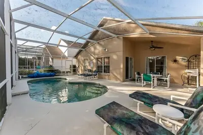 an indoor swimming pool with a glass ceiling at Beautiful Pool Home by Disney World in Orlando
