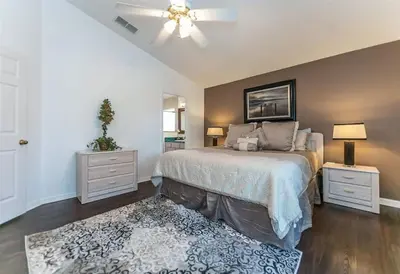 a bedroom with a bed and a ceiling fan at Beautiful Pool Home by Disney World in Orlando