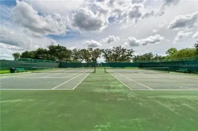 a tennis court with two tennis rackets on it at Beautiful Royal Palm Bay Condo near Disney in Kissimmee
