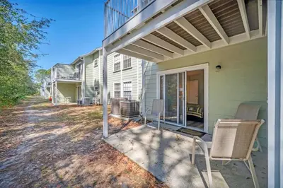 a porch of a house with chairs and a balcony at Beautiful Royal Palm Bay Condo near Disney in Kissimmee