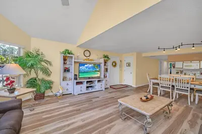 a living room with a couch and a table at Beautiful Royal Palm Bay Condo near Disney in Kissimmee