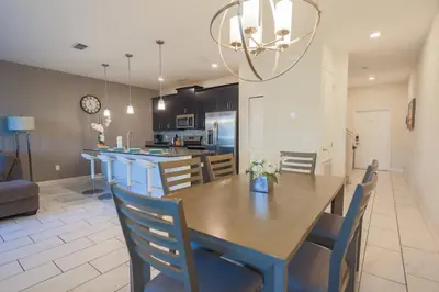 a dining room and kitchen with a table and chairs at Magical Townhome private pool in Storey Lake in Kissimmee