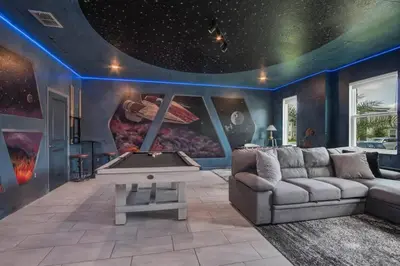 a living room with a couch and a pool table at Storey Lake Dream Villa with Private Pool in Kissimmee