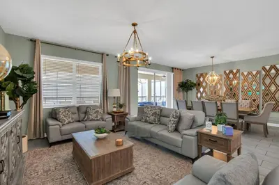 a living room with a couch and a table at Storey Lake Dream Villa with Private Pool in Kissimmee