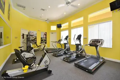 a gym with several cardio machines in a room at Wonderful Terra Verde Orlando Vacation Home in Kissimmee