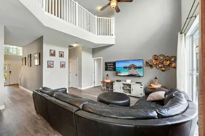 a living room with a large leather couch at Wonderful Terra Verde Orlando Vacation Home in Kissimmee